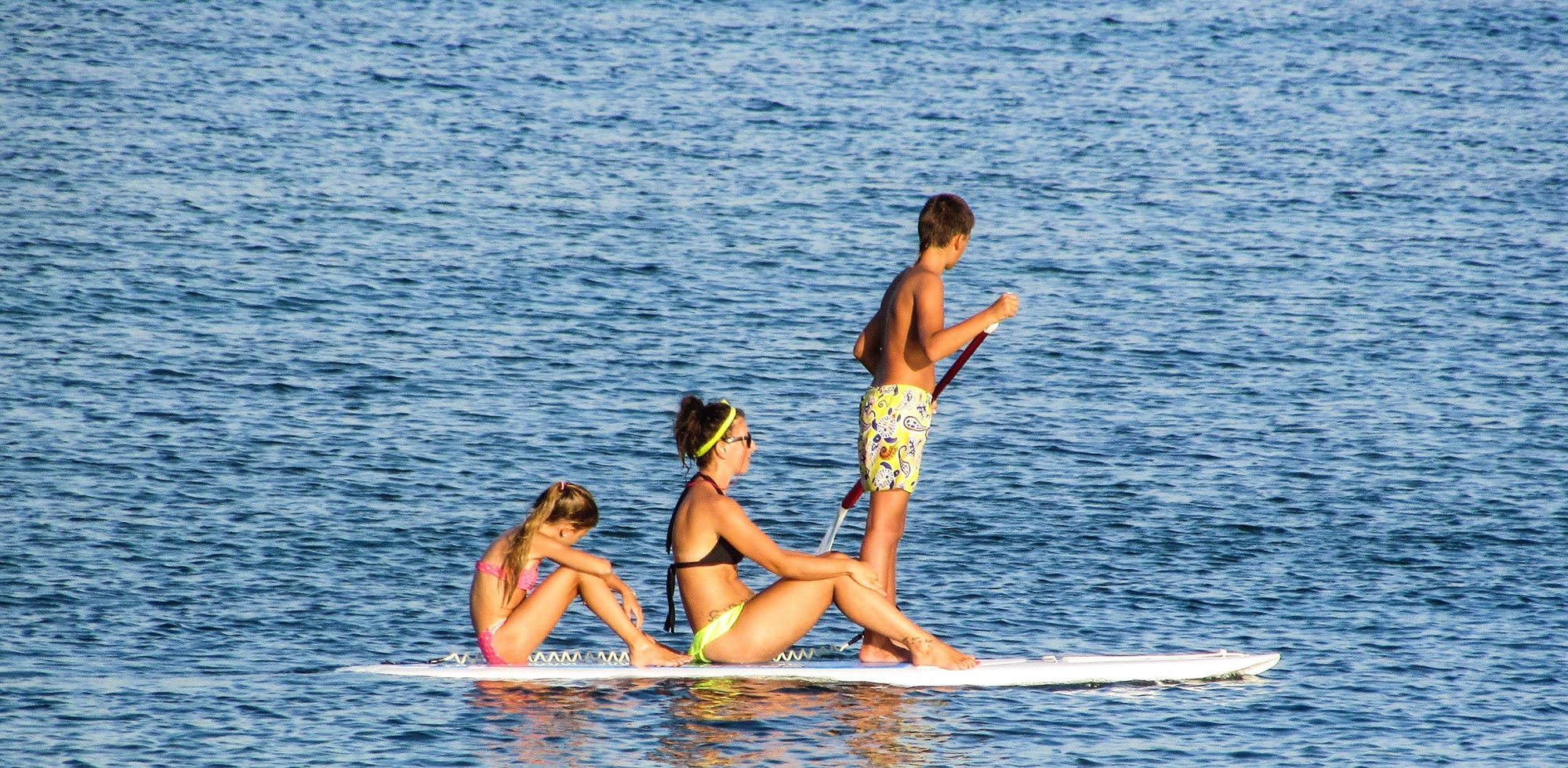 family paddle boarding on mission bay