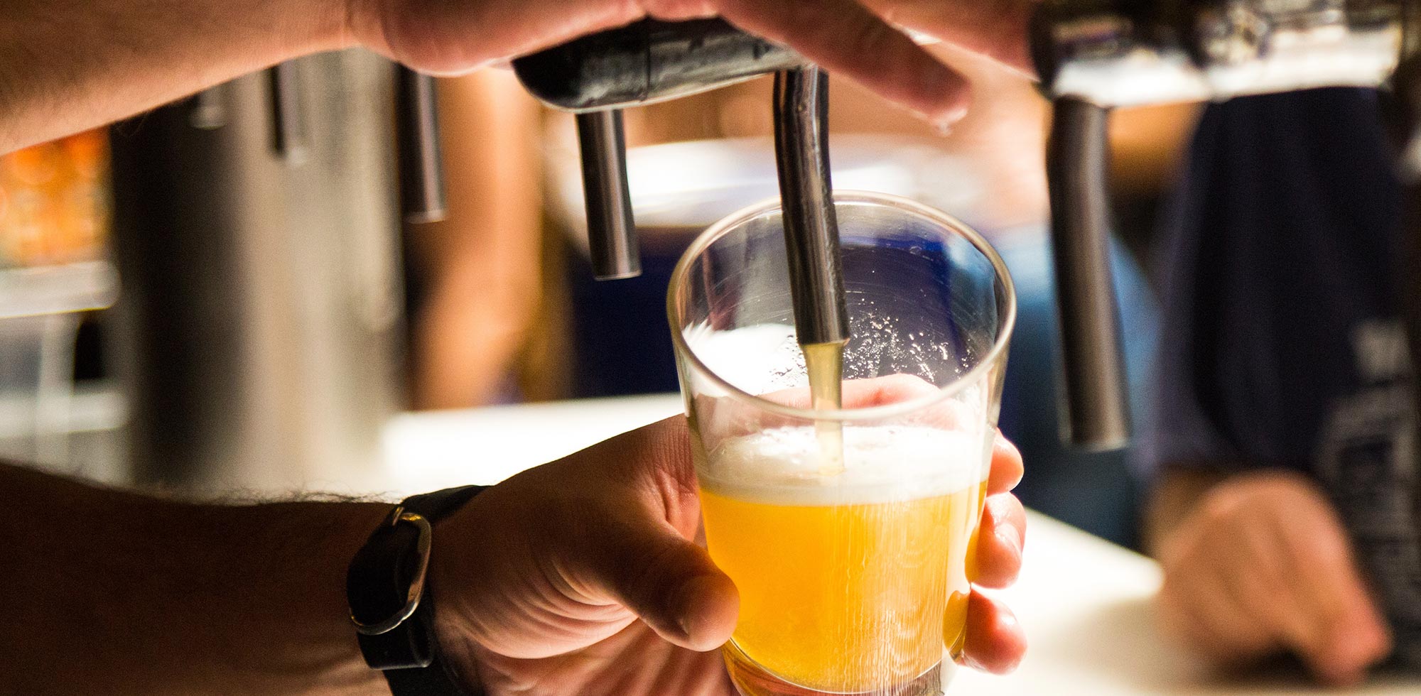 bartender pouring beer from tap