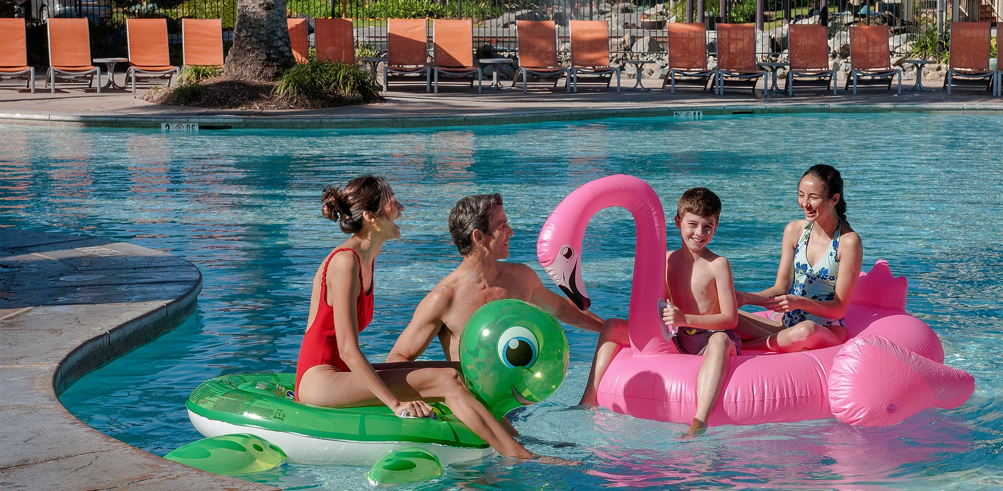 family lounging in resort pool