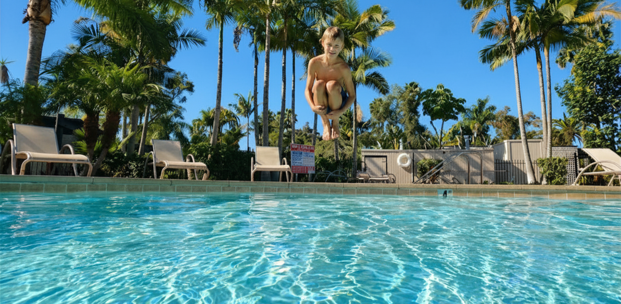 boy canonballing into pool